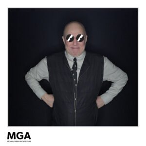 A guest poses confidently in front of a black photo booth backdrop at a Vancity Photo Booth at the MGA event, wearing digital sunglasses.