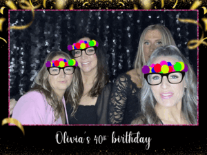 Four women pose together in a sparkly black backdrop GIF at Olivia’s 40th birthday, wearing digital party glasses in a customized photo booth rental in Vancouver.