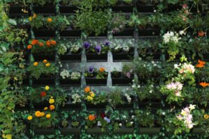 Vertical garden-style floral wall with colorful blooming flowers and greenery, ideal as a photo booth backdrop at events in Vancouver.