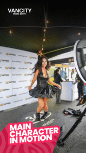 Woman spinning on a 360 photo booth platform at a Sapporo-sponsored event at Foundation One Radius in Vancouver, hosted by Vancity Photo Booth.